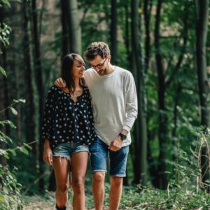 Safety in relationships creating healthy attachment. two people walking together arm in arm representing safety in connection. featured in an article about emotional enmeshment by Tess Rene Coaching