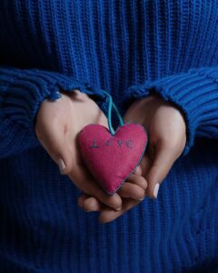 hands holding a felt homemade heart