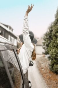 Joyful woman on a road, symbolising courage and freedom in relationships, in an article by Tess Rene Coaching
