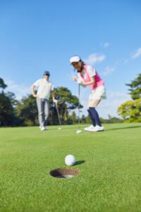 Golf ball near the cup, illustrating playful practice in Tess René Coaching’s article on low-stakes hobbies.