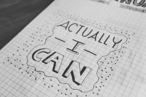 Affirmation journal saying Actually I Can, featured in Tess René Coaching self esteem article