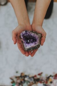 Hands holding an amethyst geode, symbolising inner strength and growth from within.