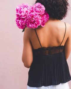 Woman with a bouquet resting on her shoulder — a gentle cue to speak to yourself like a friend, in a self-compassion article by Tess René Coaching.