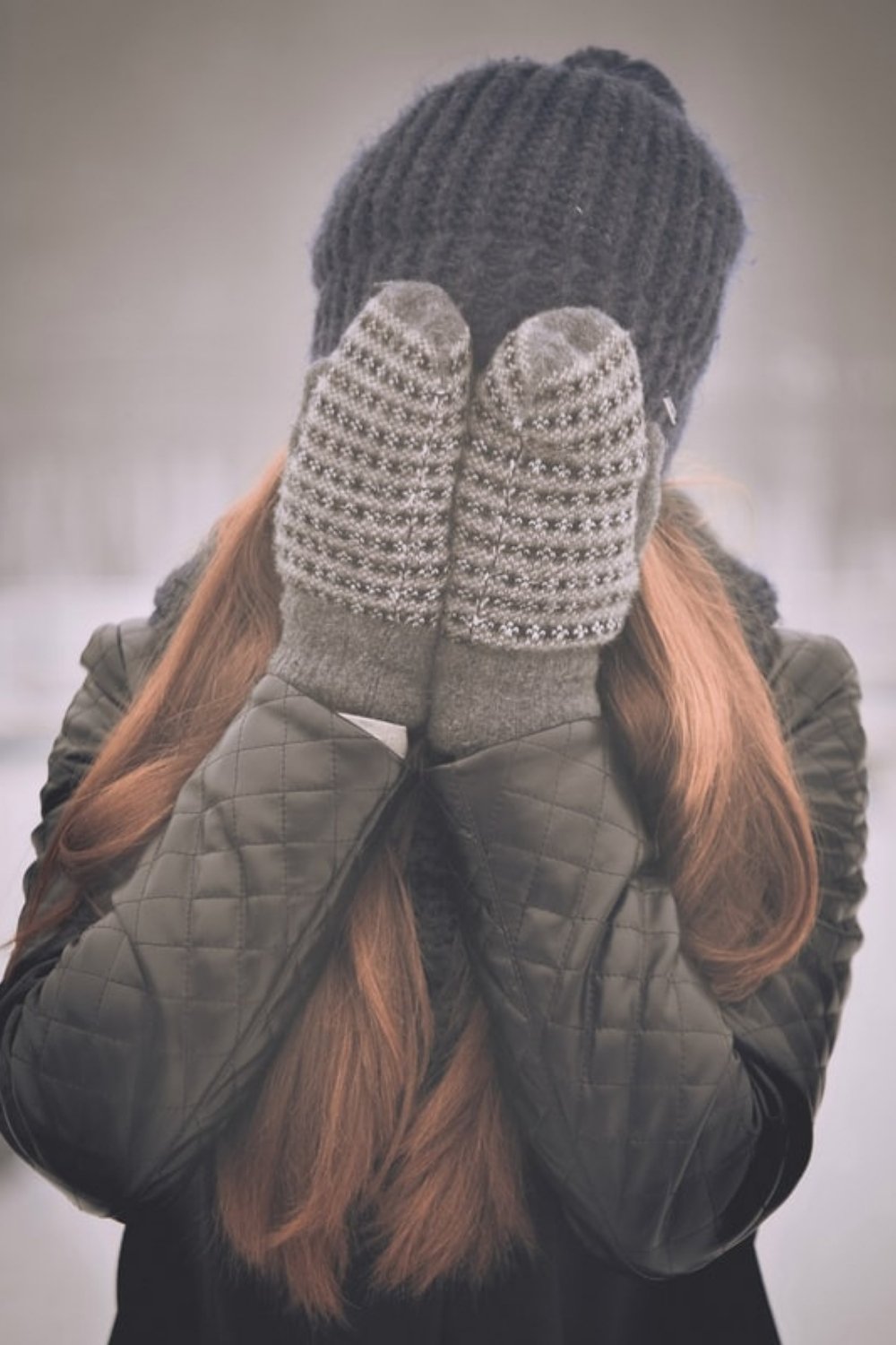 Woman covering her face in this Tess René Coaching article about how to deal with negative emotions.