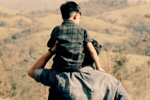 in a Tess René Coaching inner child article, a parent carries a child on their shoulders, symbolising guidance and growth