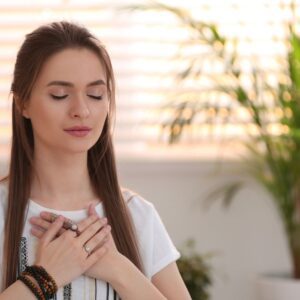 A woman practising mindful self-soothing in this Tess René Coaching article about healing the abandonment wounds through integration practices.