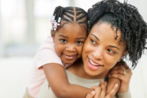 in this Tess René Coaching article about meeting our inner child, a joyful mother and child smiling together show how new patterns of connection and safety can grow.