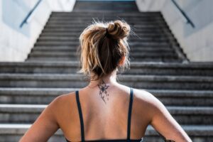 Woman facing stairs in a Tess René Coaching article about turning problems into portals with solution-focused thinking.