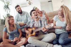 Family laughing together in a Tess René Coaching article about how early family experiences shape belonging.