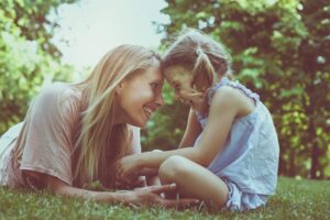 inner child compassion work in this Tess René Coaching article as a mother and child share a warm playful moment