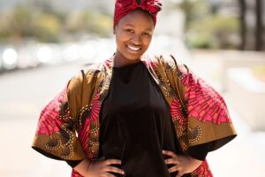 Woman smiling confidently in the sunlight shown in a Tess Rene Coaching article about trusting that .your heart already knows the way