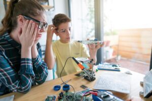 Two young people frustrated during a project, shown in this Tess René Coaching article about healing the emotional wounds that failure exposes.