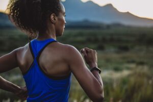 Runner moving forward at sunrise in this Tess Rene Coaching article about practical steps to embody abundance mindset.