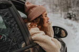 Woman looking peacefully out a car window in this Tess René Coaching article about practical steps to manage triggers so you can move forward after failure.
