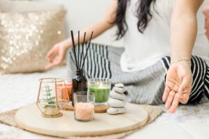 Meditative moment with candles and stones showing inner world connection in this Tess Renè Coaching article about how to be happy by yourself.