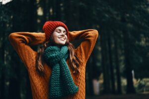 woman relaxed in nature showing nervous system acceptance and emotional ease in this Tess René Coaching article