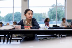unspoken expectations in friendship, a student sitting alone at a cafeteria table, featured in a Tess Renè Coaching article