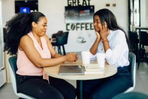calm conversation between colleagues demonstrating healthy boundaries at work, featured in this Tess Renè Coaching article