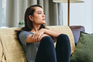 In this Tess René Coaching article, a woman sitting thoughtfully shows the inner experience of stress that lurks behind thinking too much about your relationships.