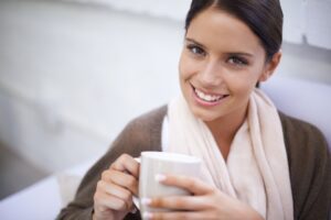 woman smiling warmly symbolising how to find joy through human connection in this Tess René Coaching article.
