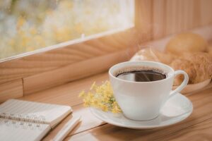 morning journaling with coffee representing simple practices that create joy in an article by Tess René Coaching