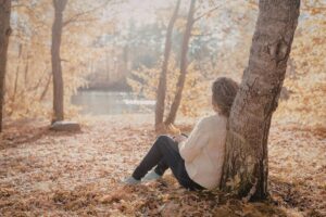 Person sitting alone outdoors in this Tess Renè Coaching article about being called overly sensitive and emotionally dismissed