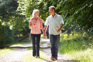 Older couple walking outdoors together in this Tess René Coaching article about building emotional safety in relationships, authentic connection, emotional safety, and self trust in relationships