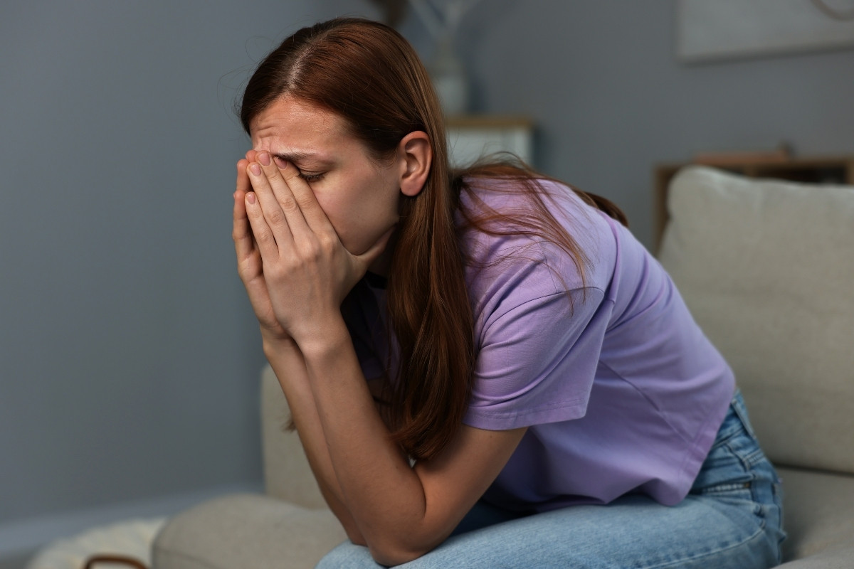 woman overwhelmed by shame and emotional distress featured in this Tess René Coaching article about guilt vs shame