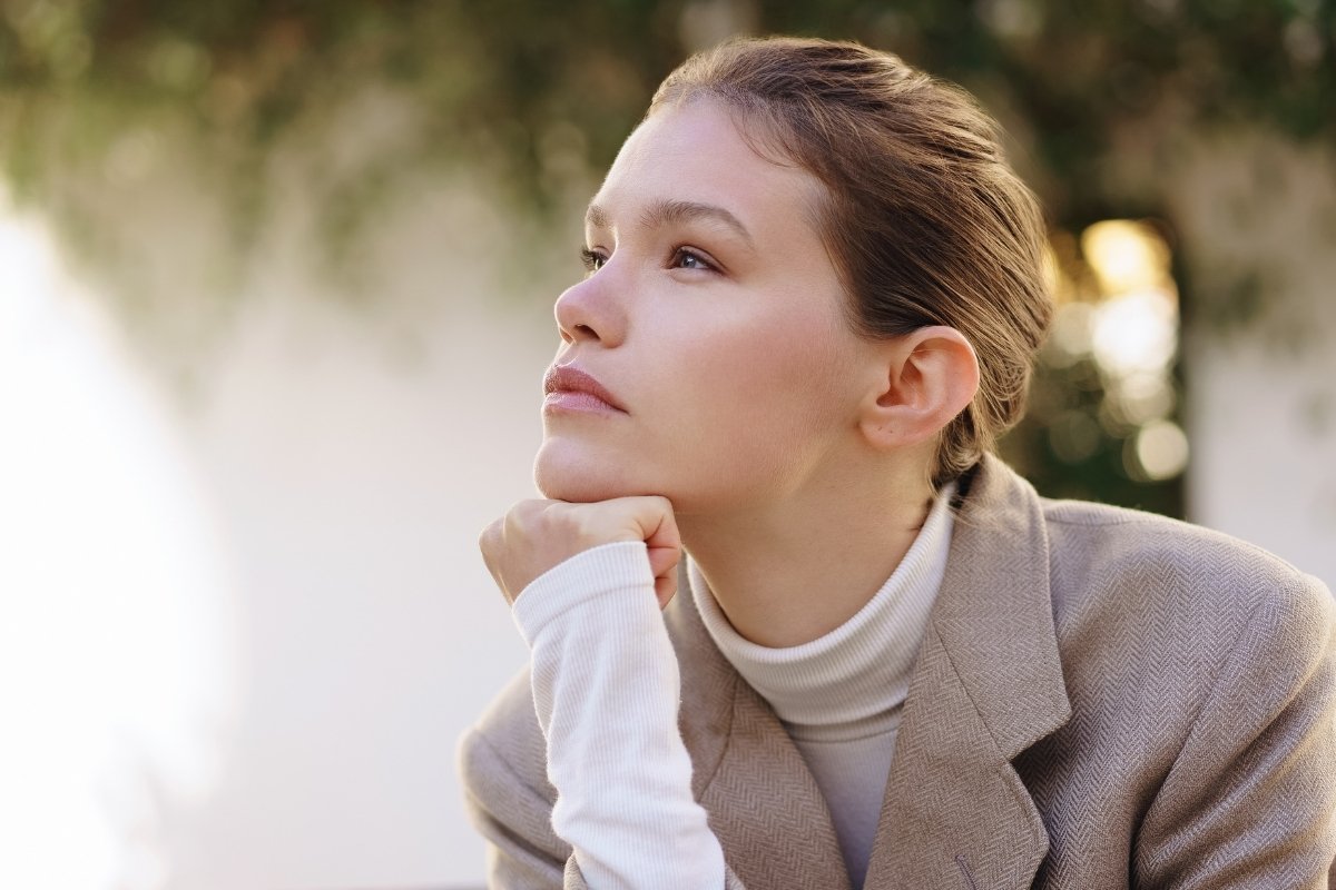 Woman reflecting quietly in this Tess Renè Coaching article about feeling overly sensitive and emotionally overwhelmed
