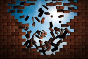 breaking wall symbolising emotional release in this Tess René Coaching article about shame held in the body